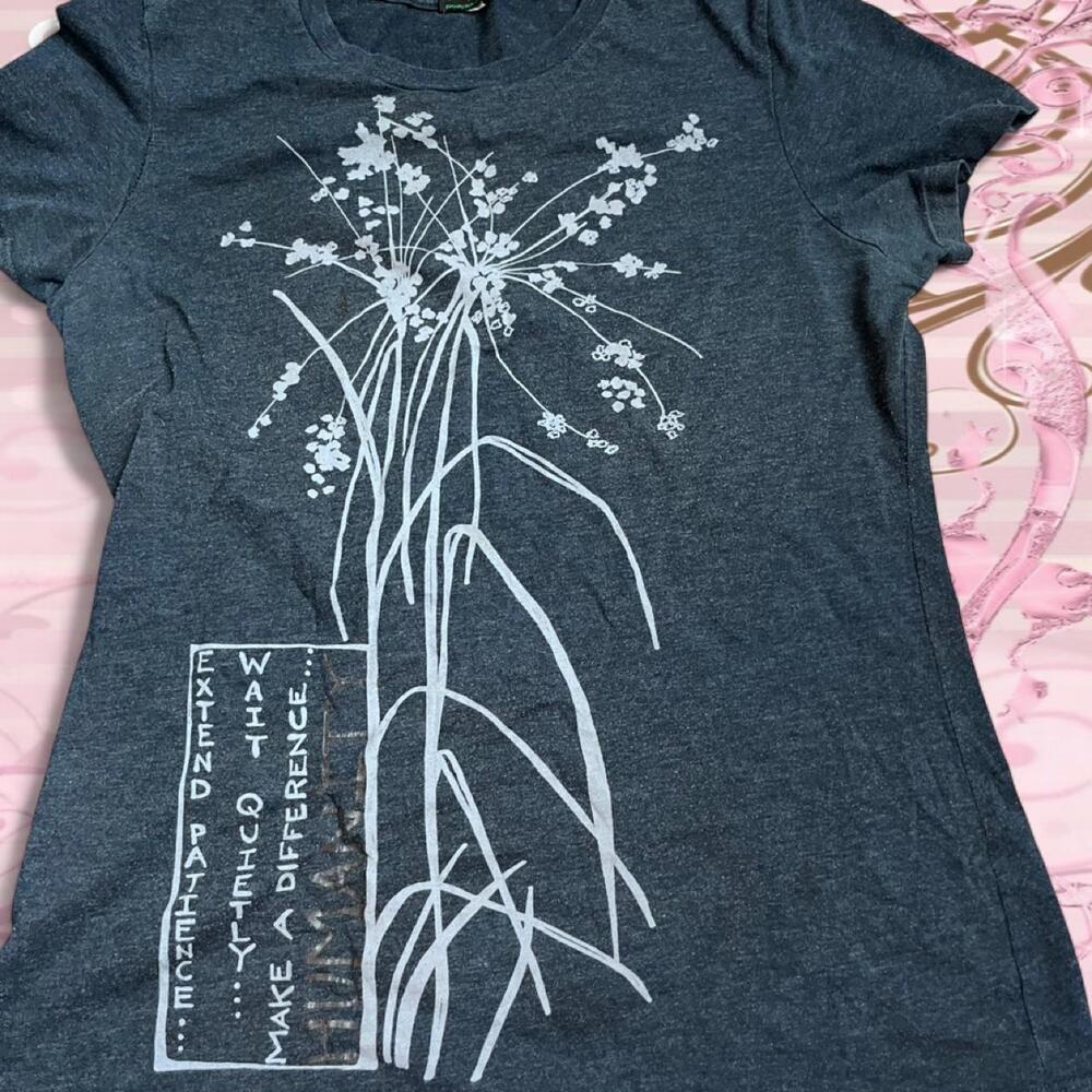 Humanity grey graphic tee with white flower design.